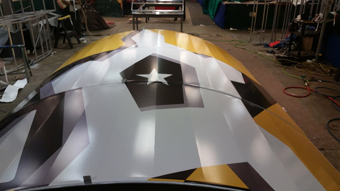 Digitally printed vinyl stapled over aluminum framework